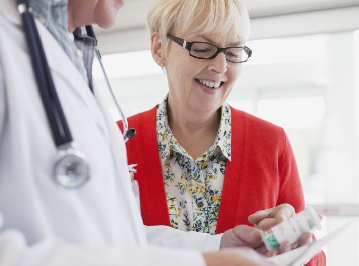 doctor reviewing prescription with woman